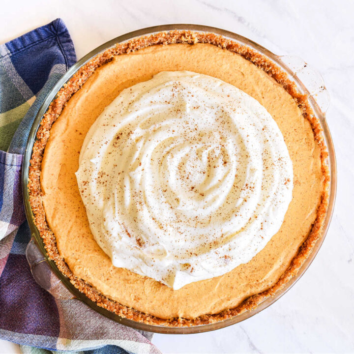 A Pumpkin Mousse Pie served next to a plaid napkin.