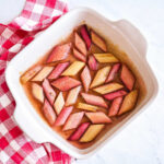 A pan of Roasted Rhubarb served next to a checked napkin.