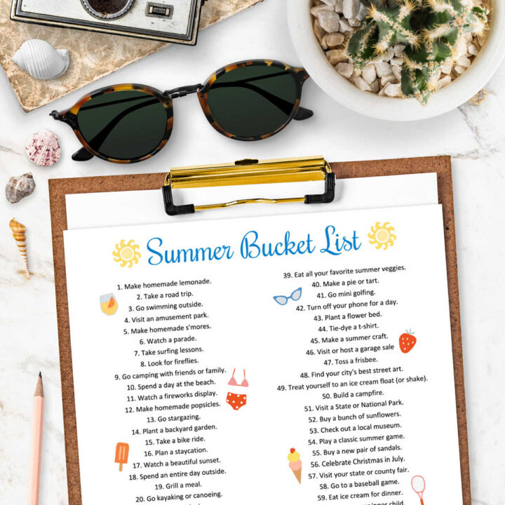 A Summer Bucket List on a clipboard next to a pair of sunglasses.