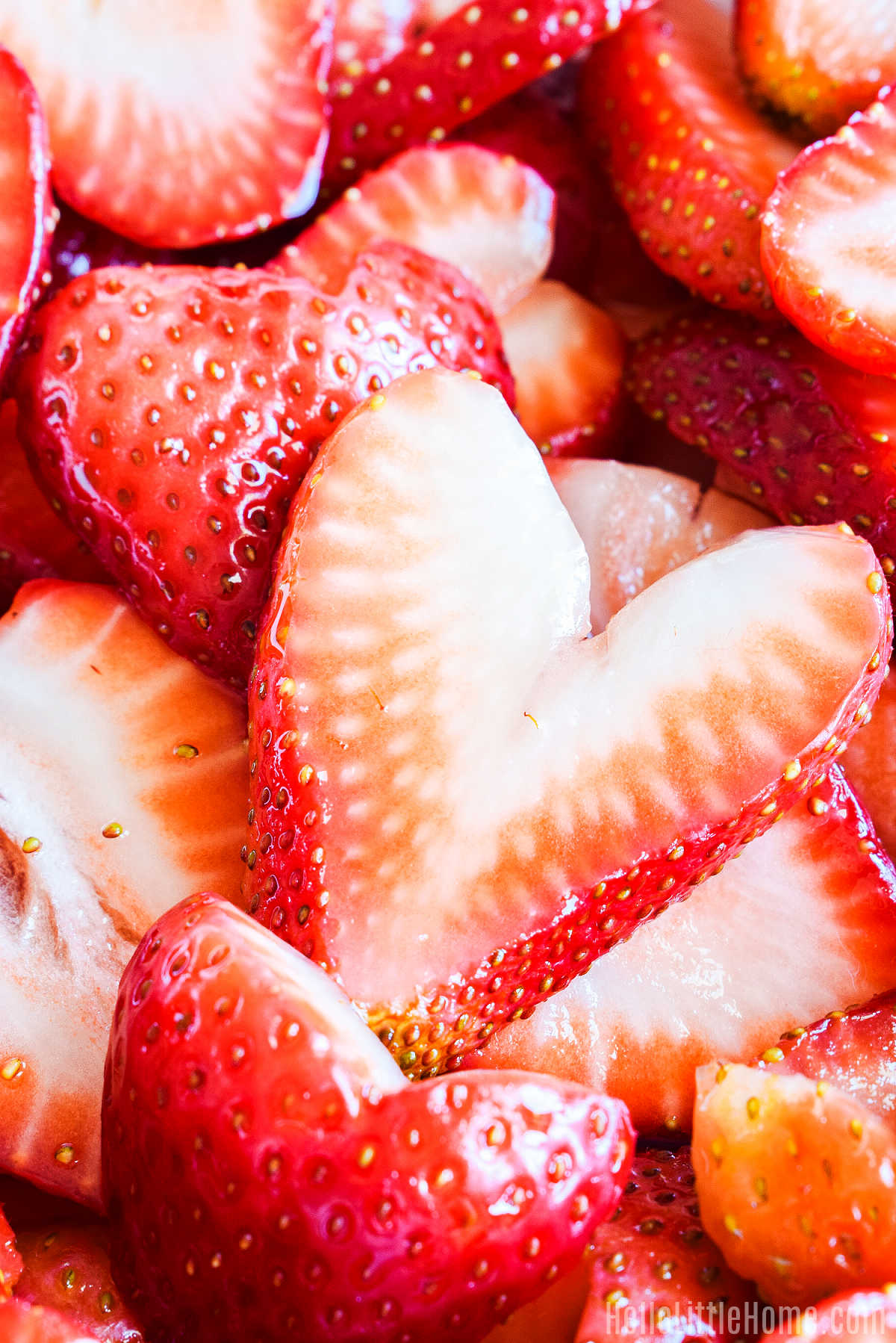 A closeup of the sliced, sugar-sweetened strawberries.