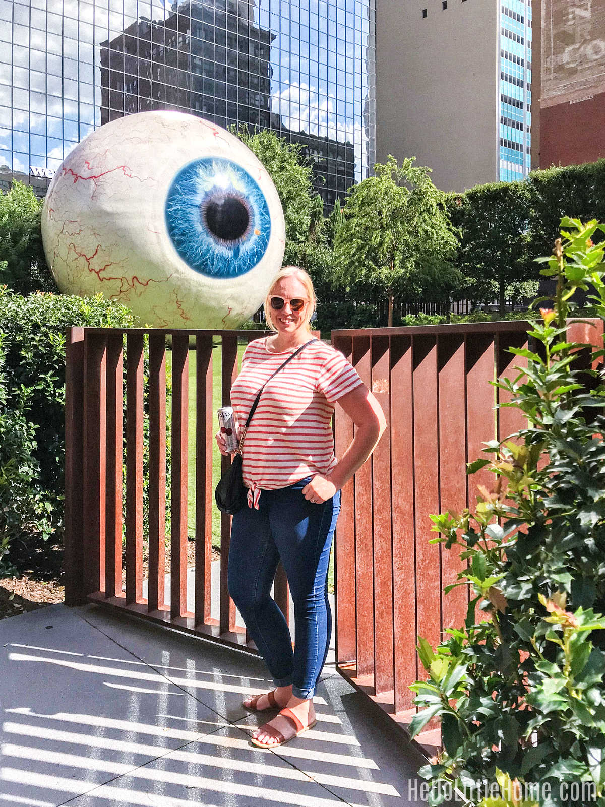 Ginnie standing in front of The Eye sculpture in Downtown Dallas.
