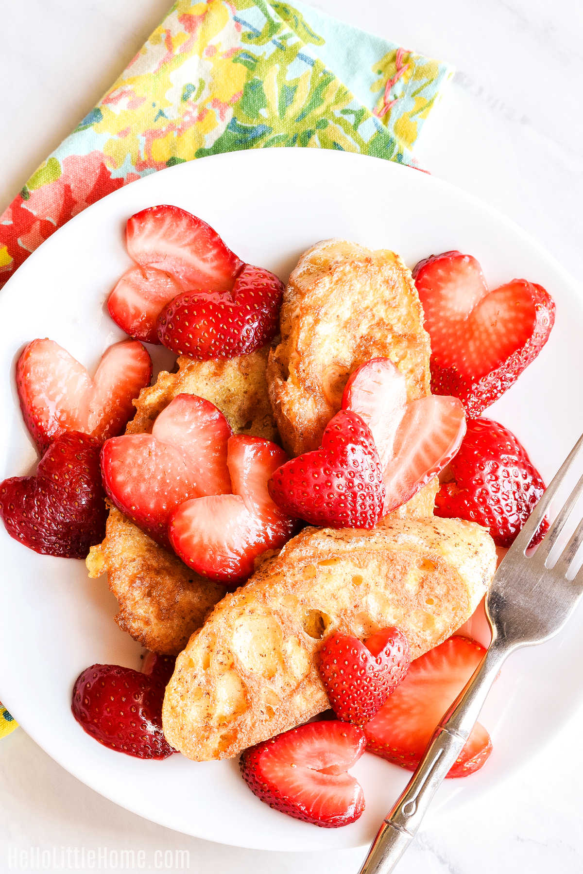 A plate of french toast topped with the homemade strawberry sauce.