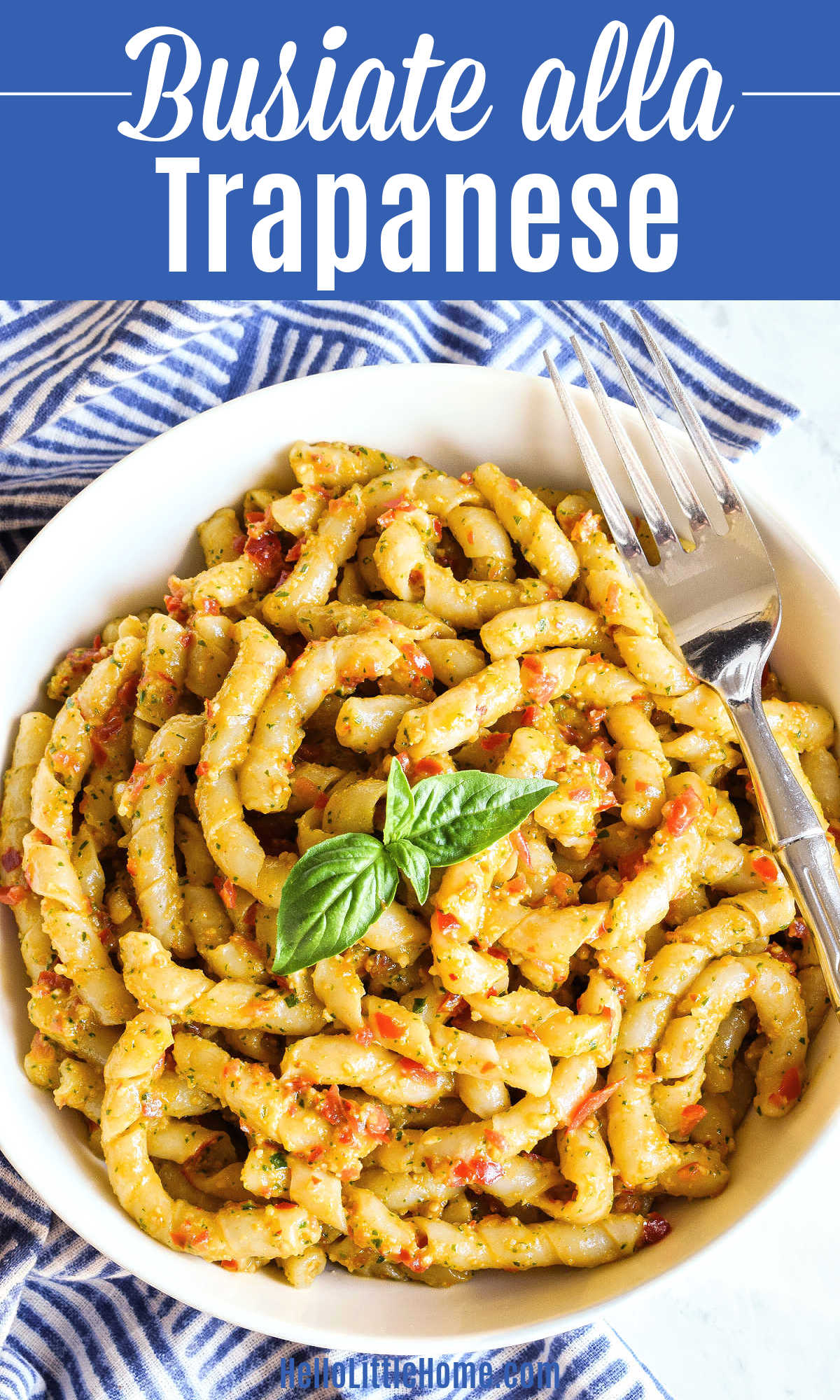 A bowl of Busiate alla Trapanese with a fork resting on the rim.