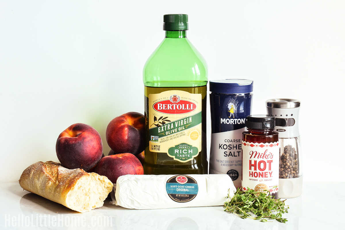 Peach Crostini ingredients arranged together on a marble counter.