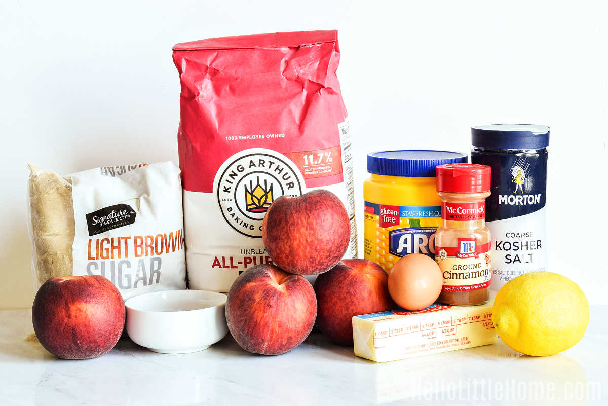 Peach Galette ingredients arranged together on a marble counter.