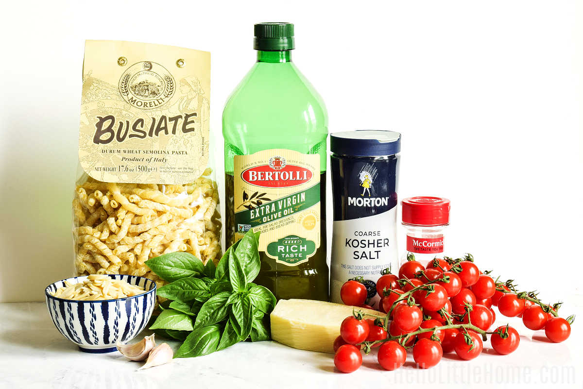 Pesto alla Trapanese ingredients arranged on a marble counter.
