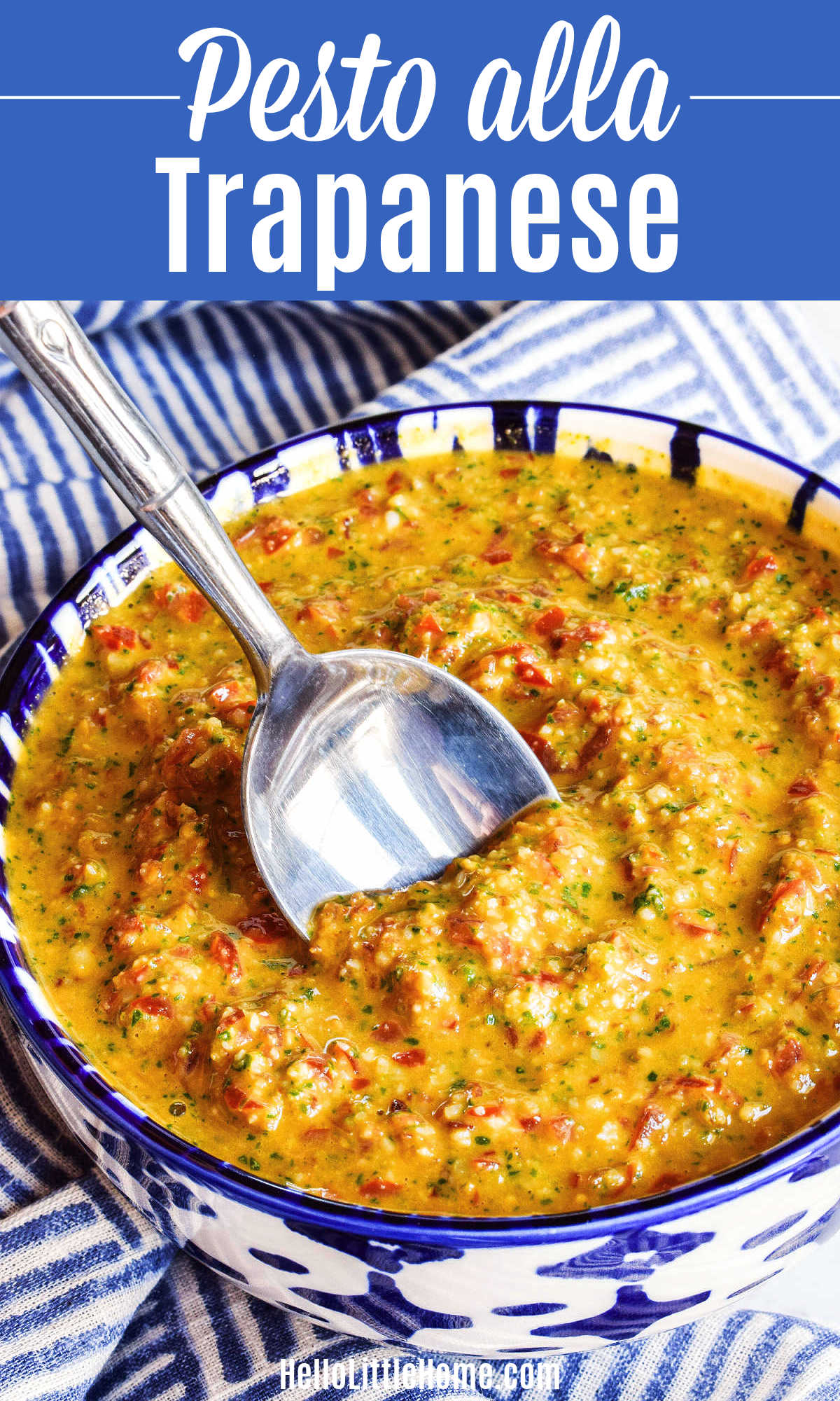 A spoon stirring a bowl of Pesto alla Trapanese.
