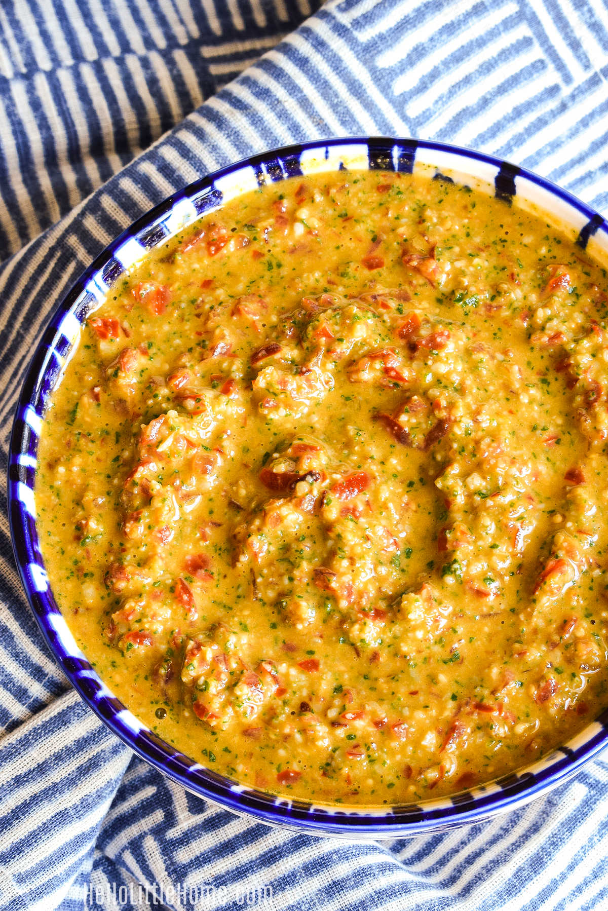 A bowl of Pesto Trapani on a striped napkin.