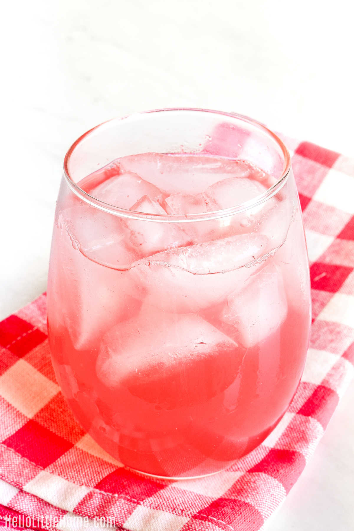 A glass of the Watermelon Fizzy Drink on a checked napkin.