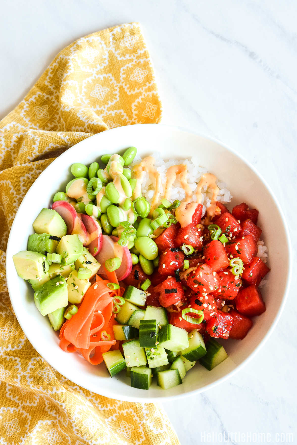 A poke bowl topped with Sriracha Mayo Sauce.