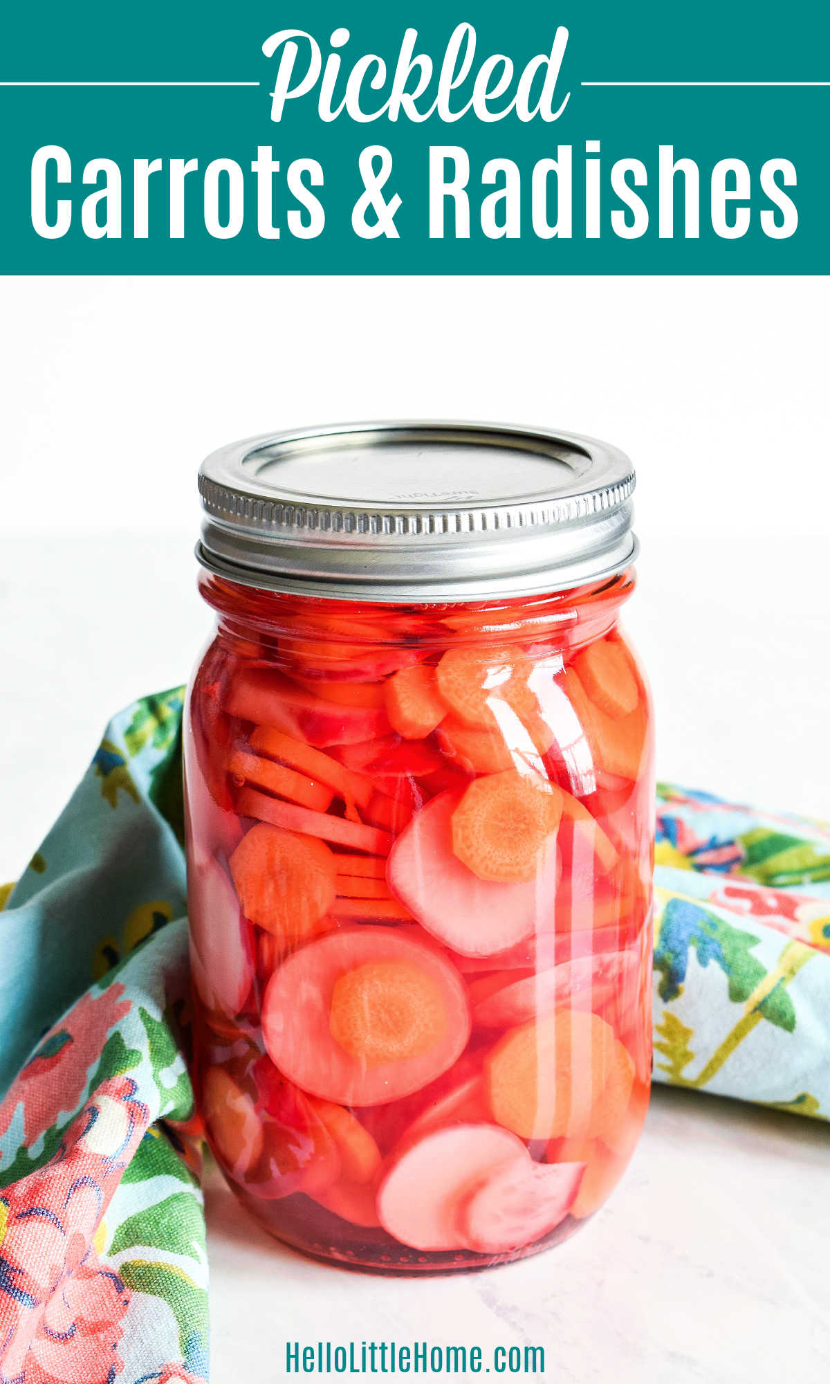 A jar of Pickled Carrots and Radishes and a napkin on a marble counter.