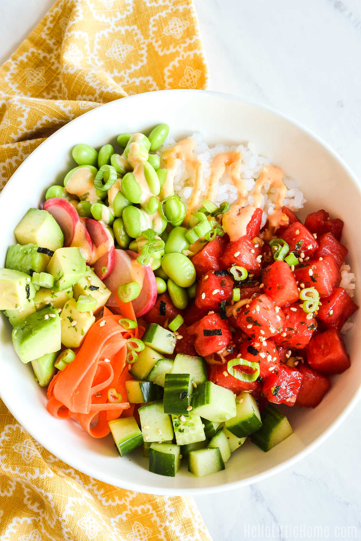 Watermelon Poke served in a white bowl with rice and toppings.