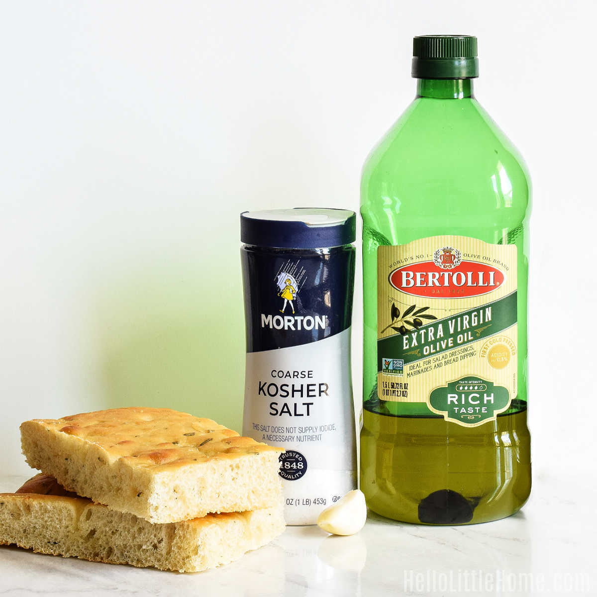 Ingredients to make Focaccia Crostini arranged together on a marble counter.