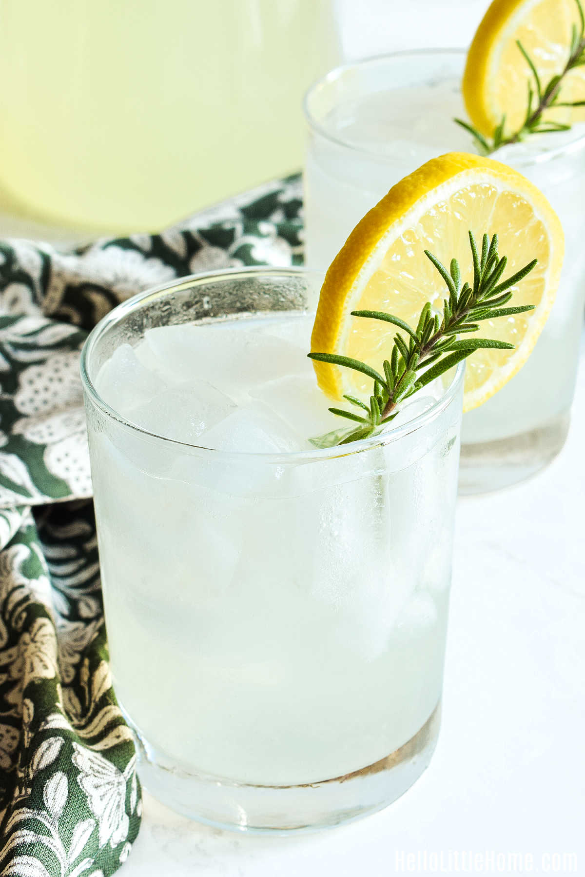 The Lemonade Rosemary drink served in glasses next to a patterned napkin.