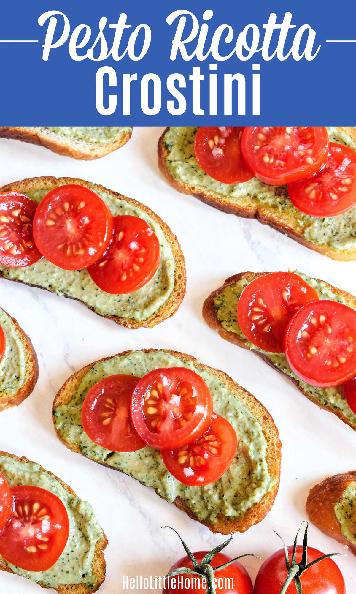 The Pesto Ricotta Crostini recipe served on a marble tray.