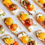 Roasted Tomato Crostini served on a marble tray.