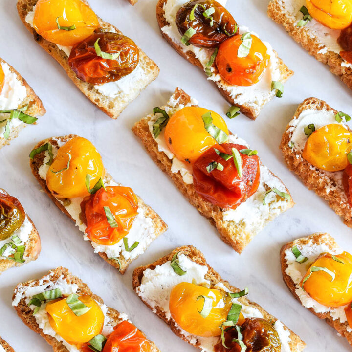 Roasted Tomato Crostini served on a marble tray.