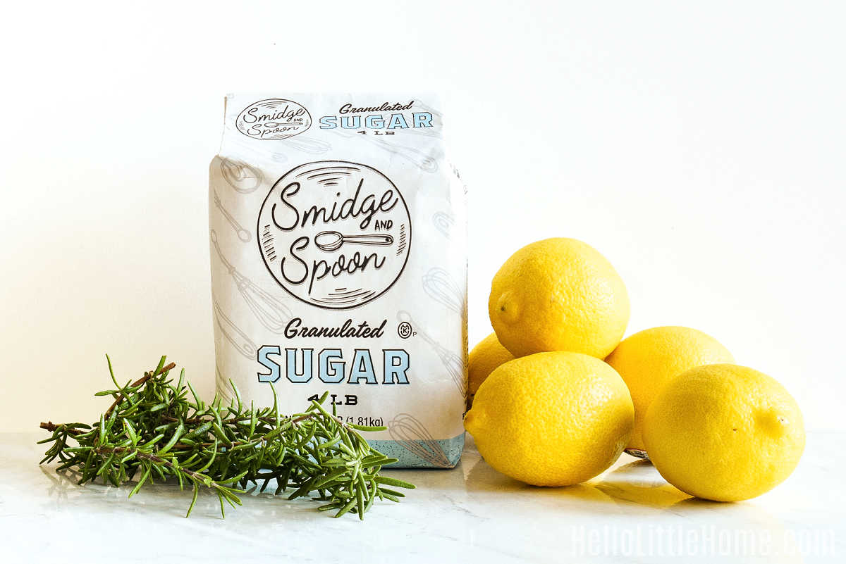 Rosemary Lemonade ingredients arranged together on a marble counter.