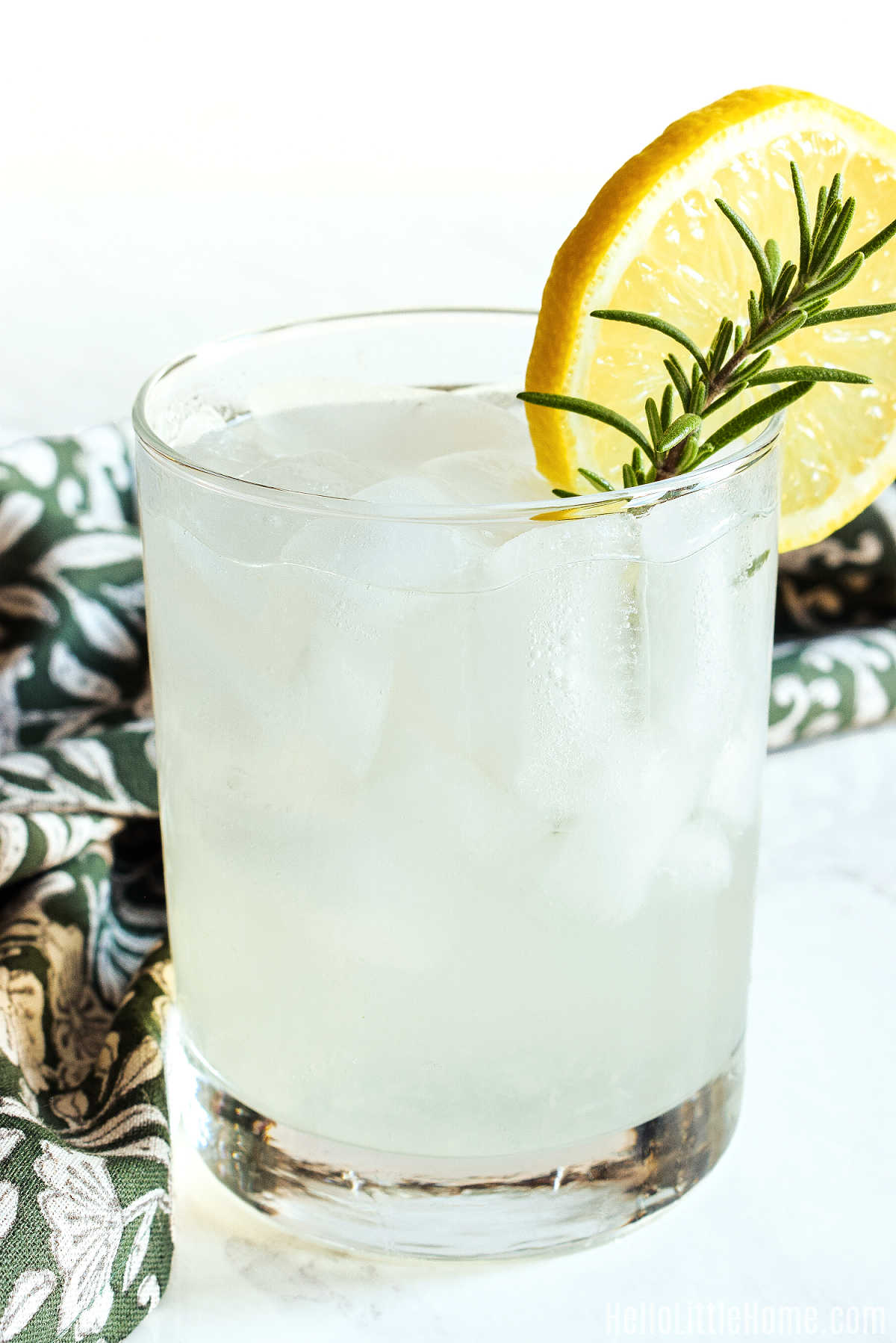 The finished drink served with a napkin on a marble counter.