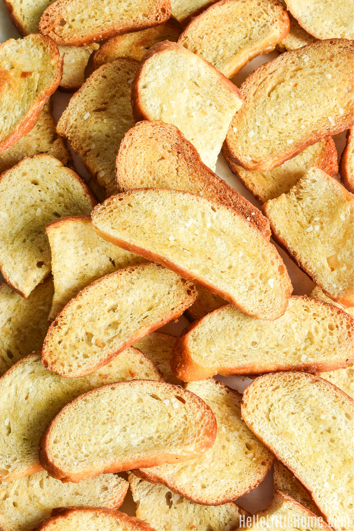 Slices of Sourdough Crostini stacked on top of each other.