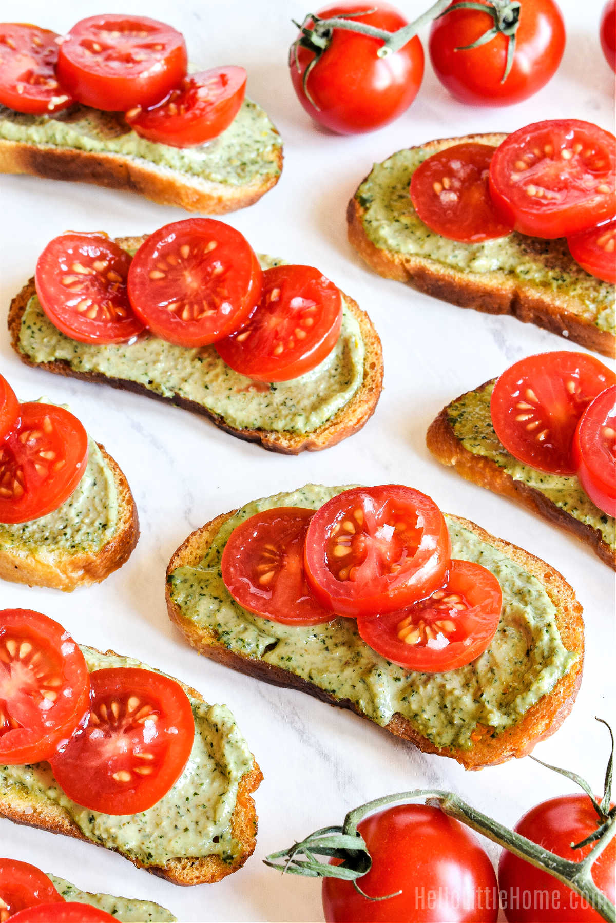 The finished sourdough appetizer topped with pesto and tomatoes.