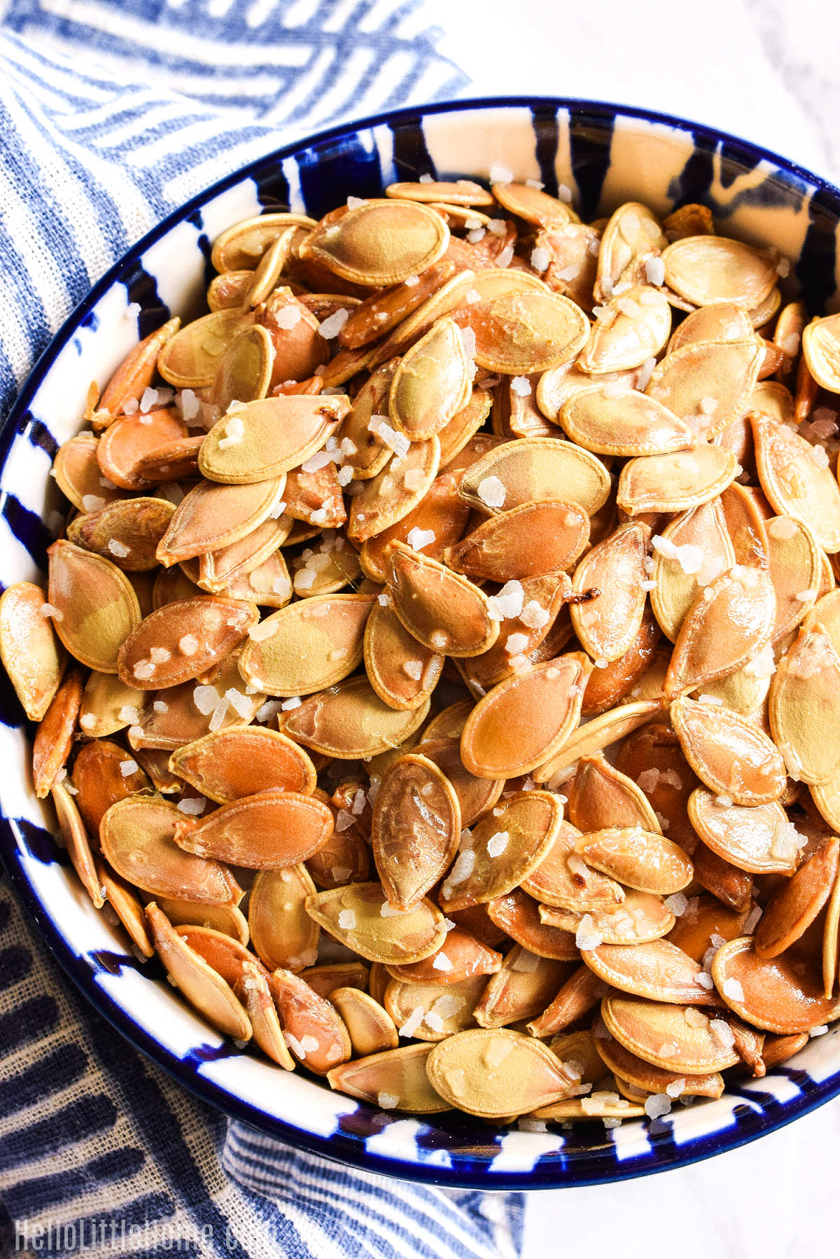 A bowl of the baked seeds served with a napkin.