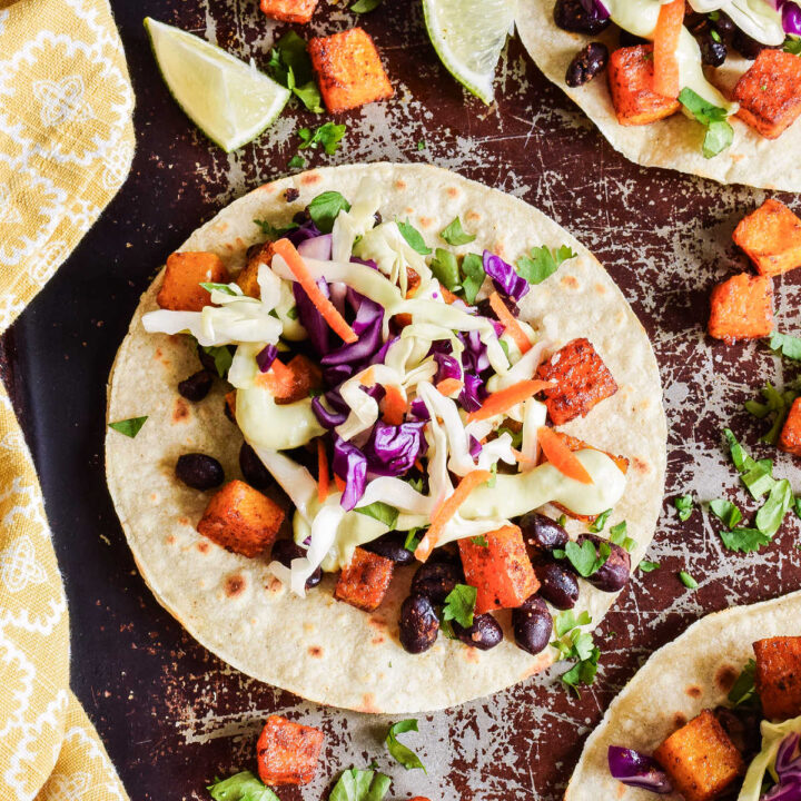 Butternut Squash Tacos served on a tray with a yellow napkin.