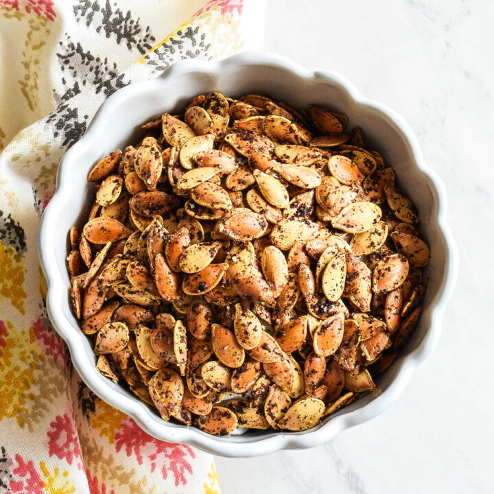Cajun Pumpkin Seeds served in a bowl with a patterned napkin.