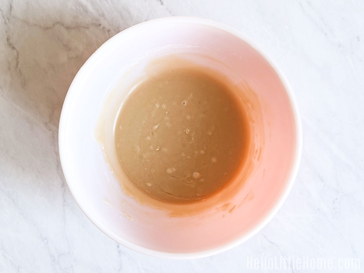 A bowl of the finished maple glaze on a marble counter.
