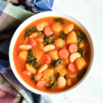 A bowl of Pumpkin Stew served with a plaid napkin.