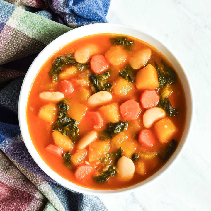 A bowl of Pumpkin Stew served with a plaid napkin.