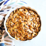 Salt and Vinegar Pumpkin Seeds served in a white bowl with a napkin.